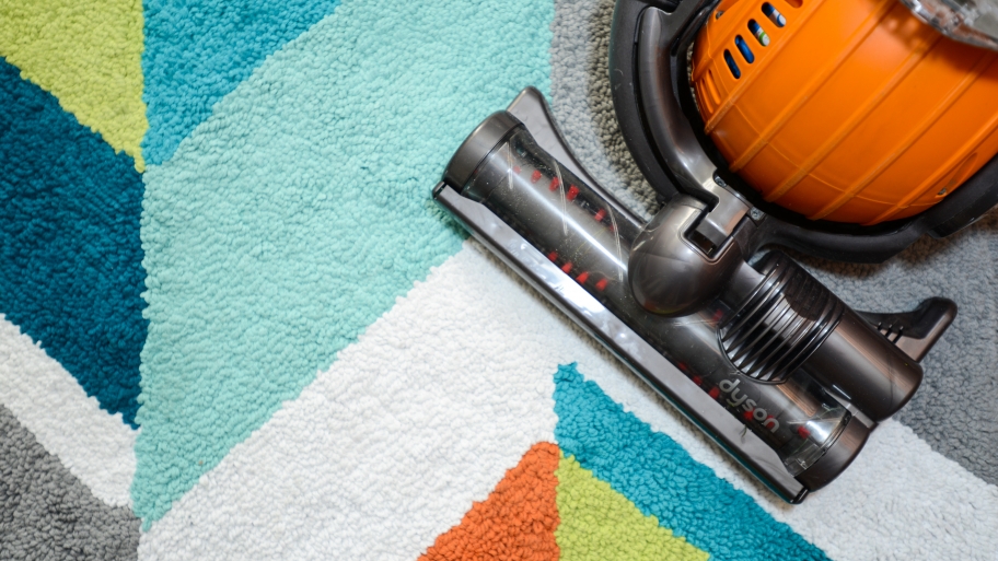 vacuum on colorful rug