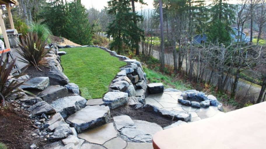 Patio slate used to build steps and walking area to a firepit and outdoor hot tub and spa area.