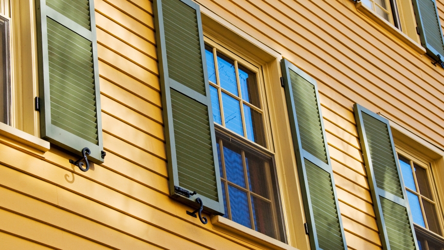 yellow house with green shutters