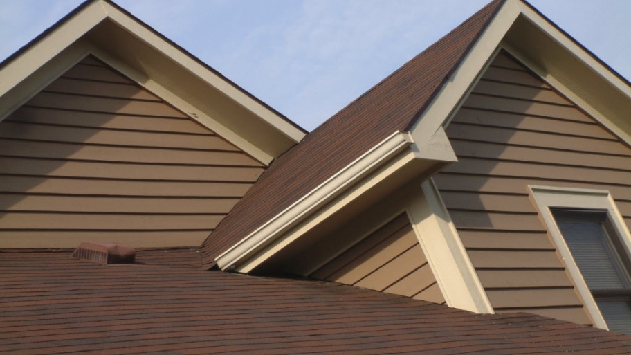 a house with brown siding and white trim