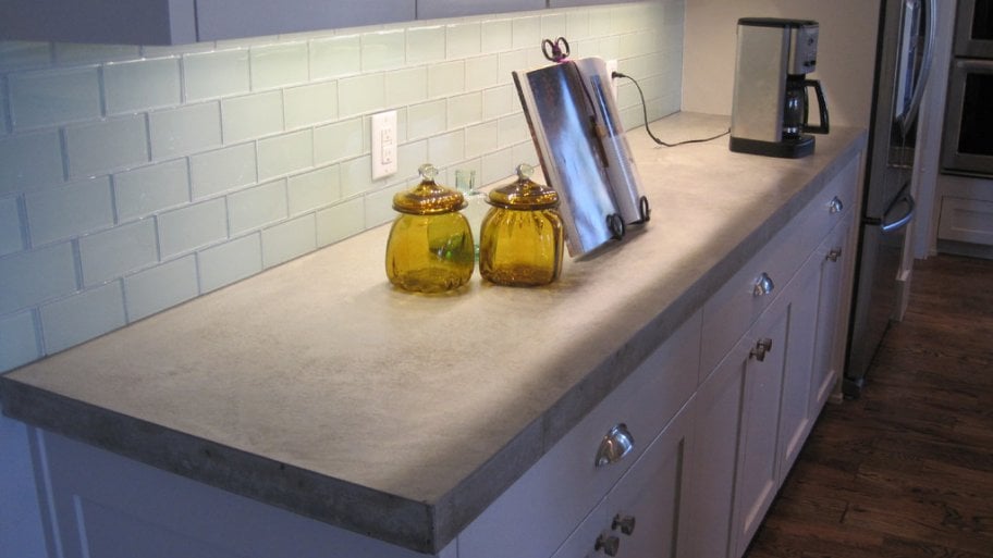 Task lighting under-cabinet lighting with a book and coffee maker on counter