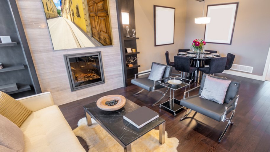 Modern living room with wood floors and artwork above fireplace