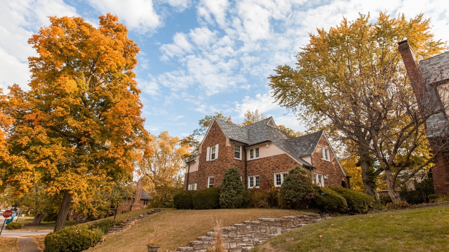 fall trees next to old home