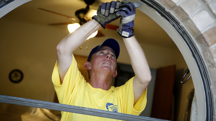 man replacing window