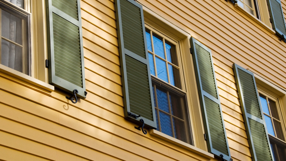 green shutters on windows on house exterior
