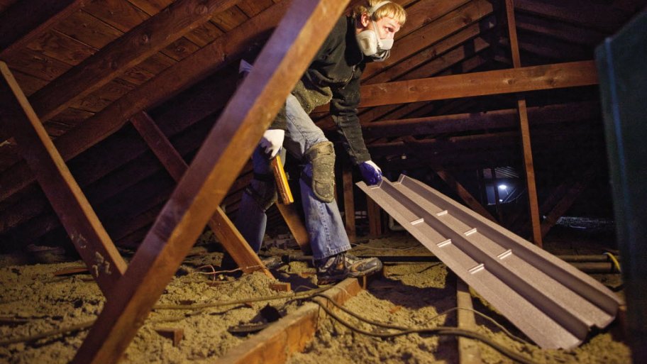 insulation professional working in attic