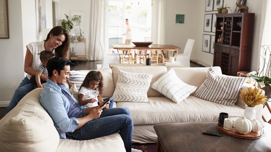Young family smiling in living room
