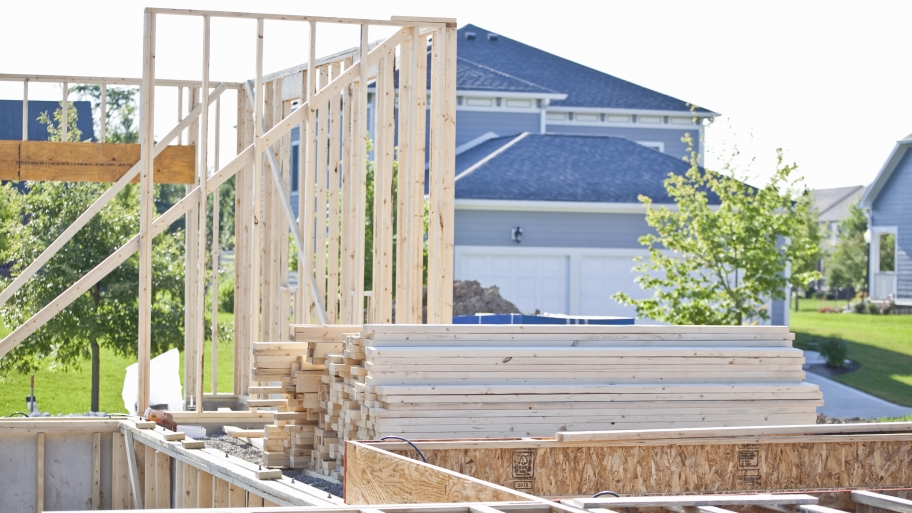 stacked lumber at home construction site
