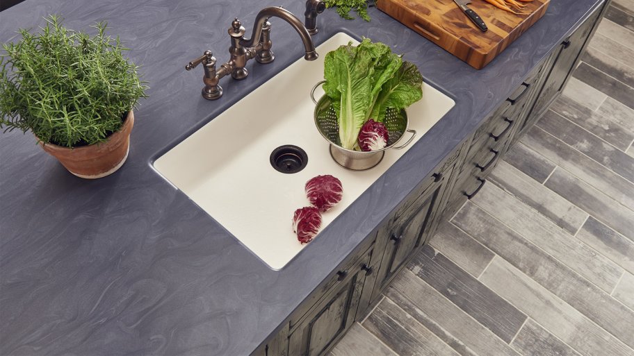 Dark Corian counter around kitchen sink