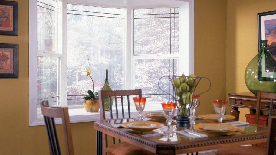 White bay window and brown kitchen table.