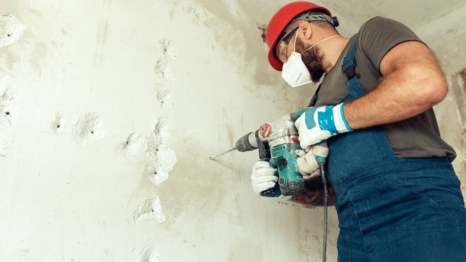 Professional preparing concrete wall to be demolished