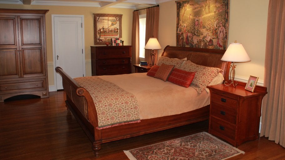 master bedroom with artwork and area rugs