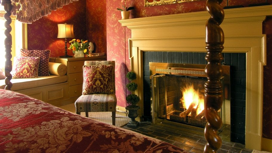 master bedroom with chair and fireplace