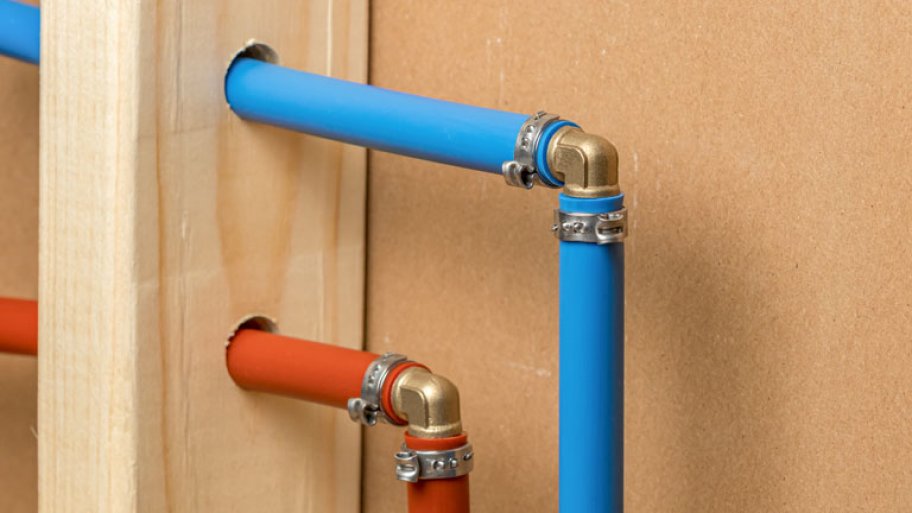 Pex plastic water supply plumbing pipe in wall of house