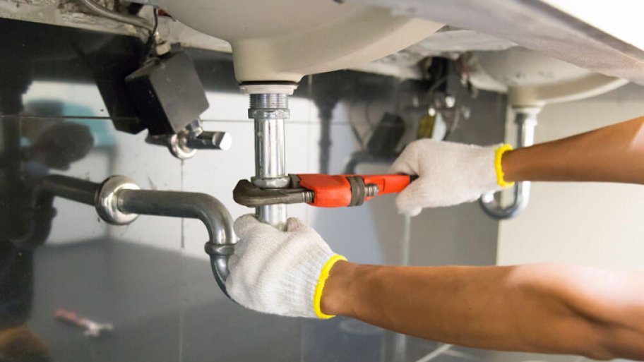 Plumber fixing pipes