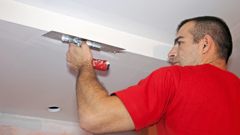 drywall contractor finishing a smooth ceiling