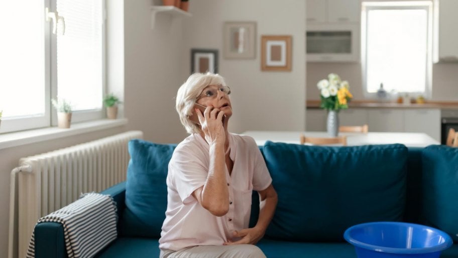 A woman calling a plumber for water leakage