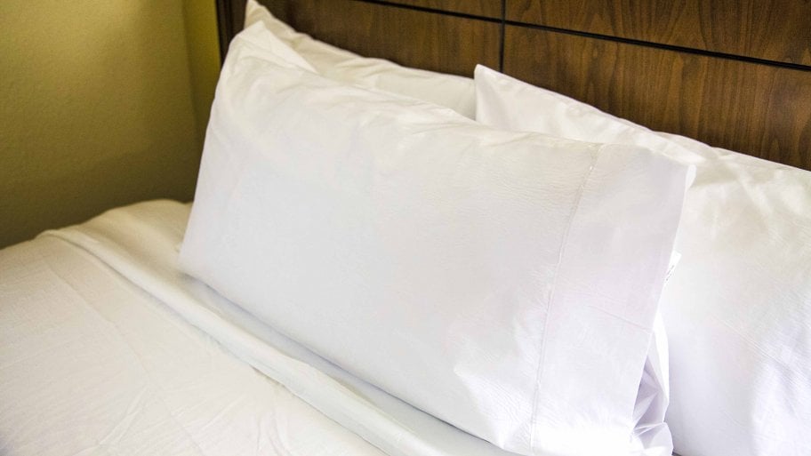 bed with pillows and sheets