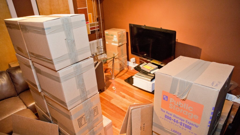 Boxes and a television being packed for a move