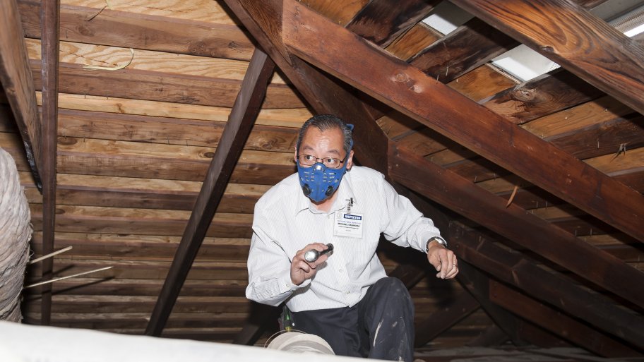 electrician checks for an attic fan