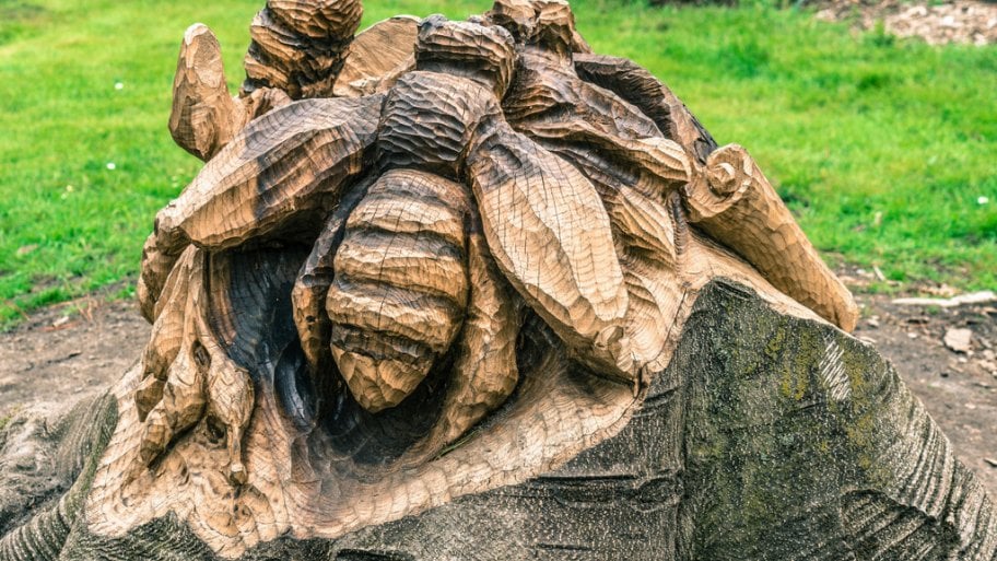 A tree stump carving of bees