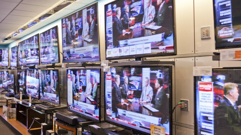 a bunch of flat screen tvs showing espn