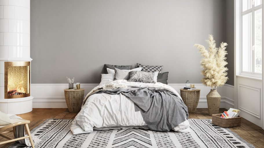 a furnished bedroom with gray walls