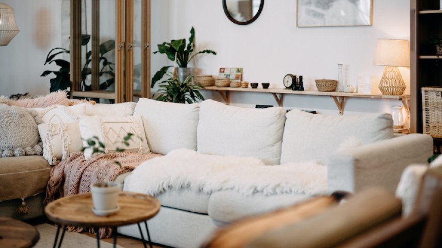living room interior featuring light cream and tan wood tones with black accents and cozy, soft lighting
