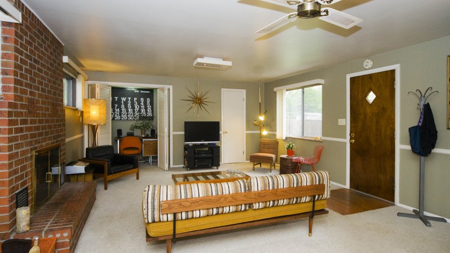 living room with couch, fireplace and ceiling fan