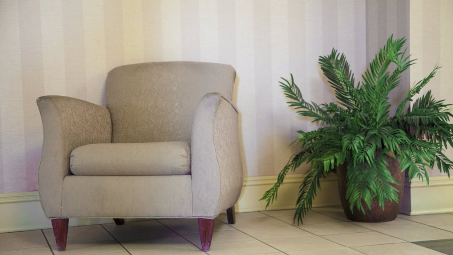 a tan fabric chair with a house plant