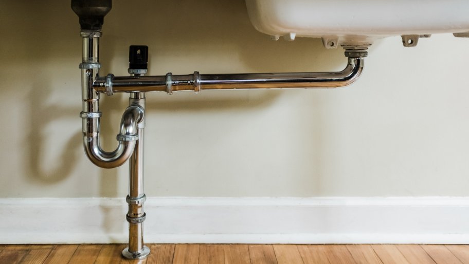 Close-up of water pipes under a sink