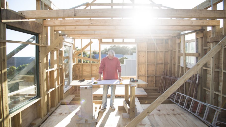 contractor stands at work table in a new house being built