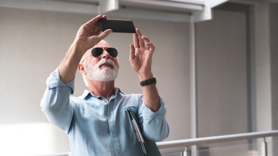 Contractor taking photos of project with smartphone