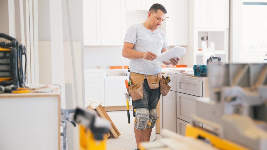 A contractor working on fitting a new kitchen