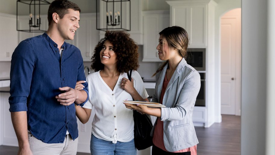 realtor showing couple apartment
