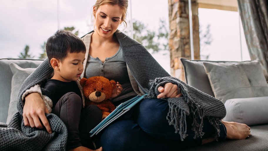 Mom and child read under blanket