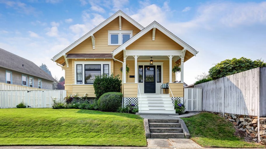 Craftsman-style house with yellow exterior paint and white accents Craftsman-style house with yellow exterior paint and white accents