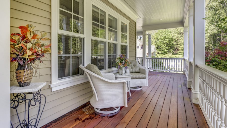 a deck features patio furniture, wood floor, and four large windows
