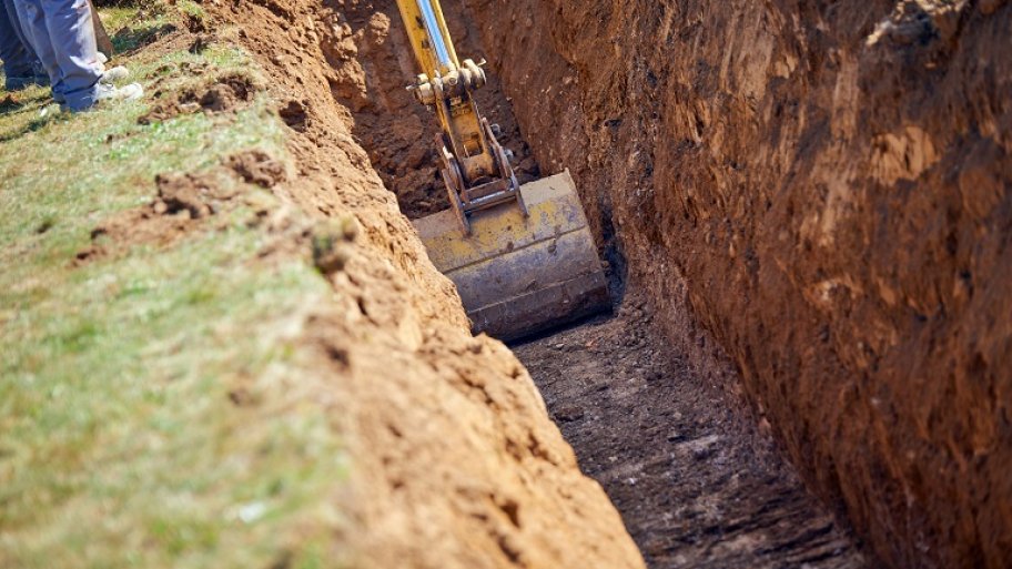 Excavator digging a trench Excavator digging a trench