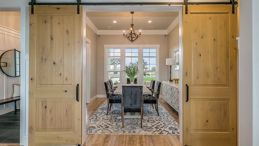 Modern dining room with a double barn door entrance