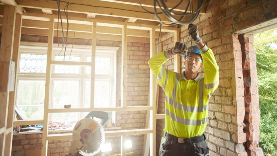 A male electrician working on site