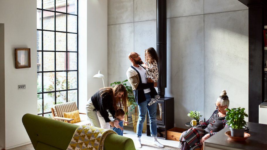 a multi-generational and diverse family enjoys a bright modern living room at home
