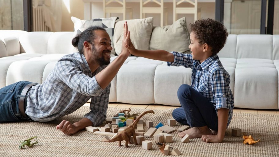A father playing with his son in the living room (Photo by fizkes - stock.adobe.com)