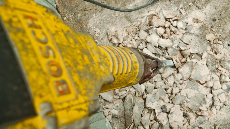 jackhammer busts up concrete foundation