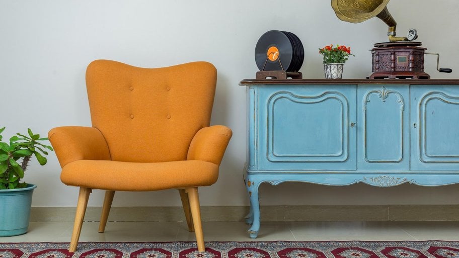 Retro armchair with antique sideboard