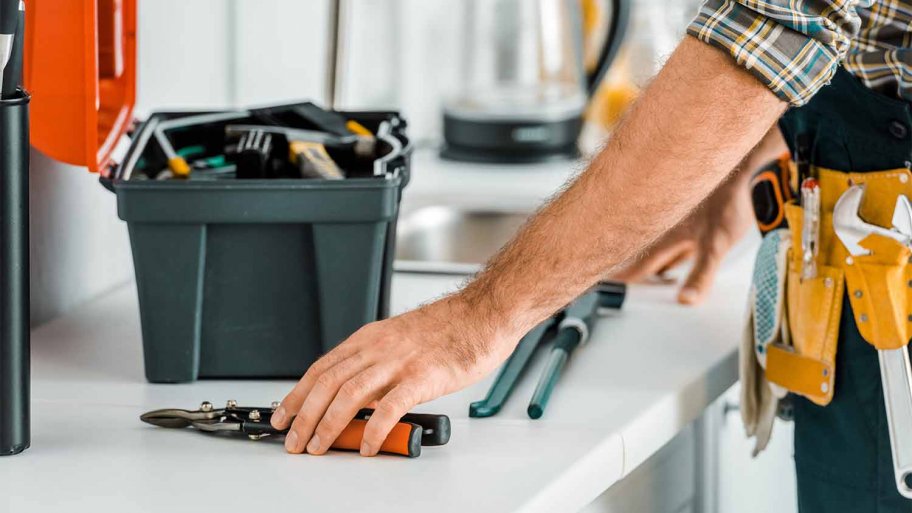handyman with tools on counter