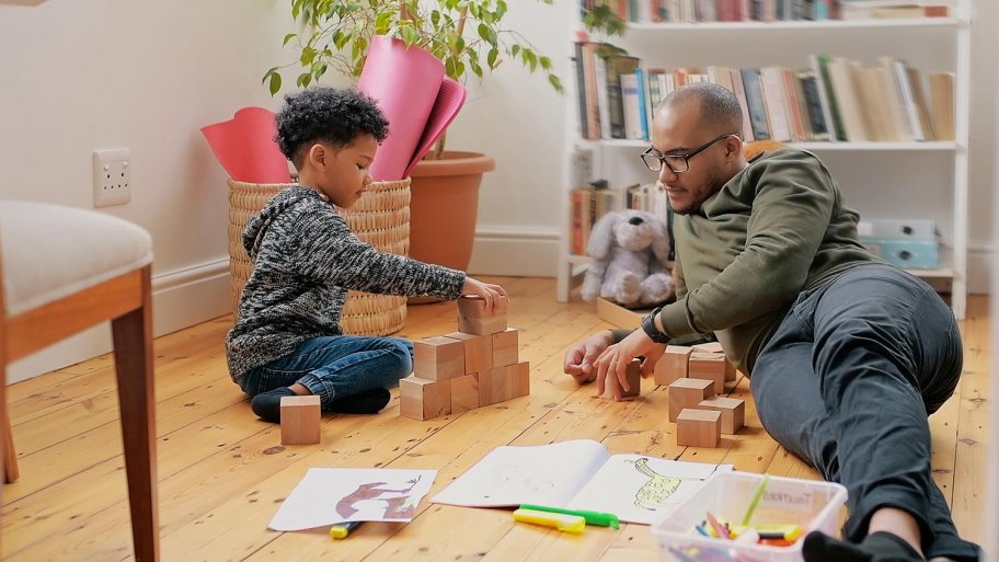 Dad and son build blocks on hardwood floors