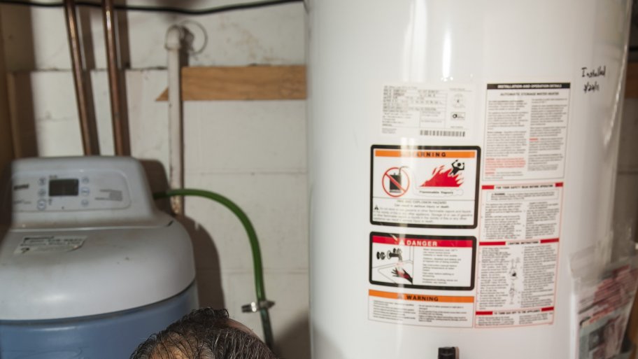 home inspector looking at water heater