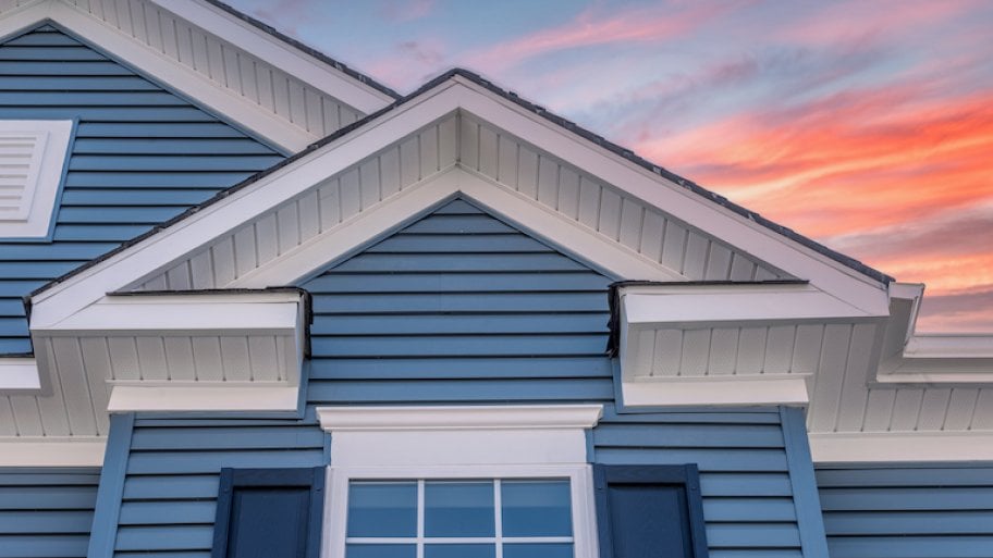 house with blue siding with sunset in background