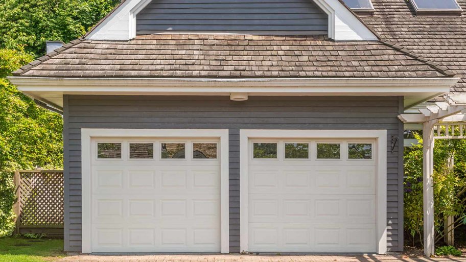 grey house with white garage doors